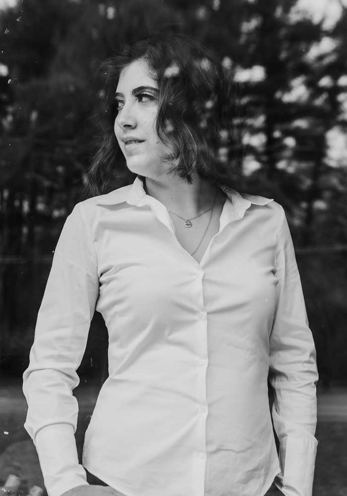 Black-and-white photo of attorney Daniela Albert wearing a white-collared shirt